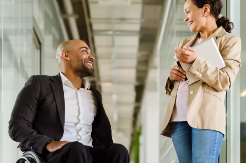 Disabled man in wheelchair talking with support coordinator